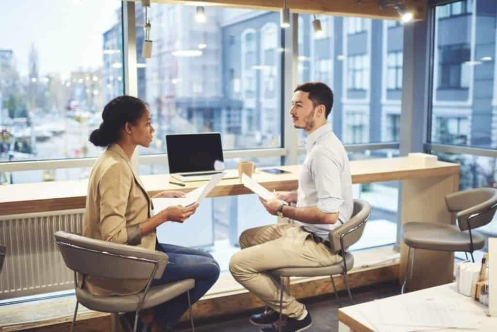 two collegues sitting in front of computers